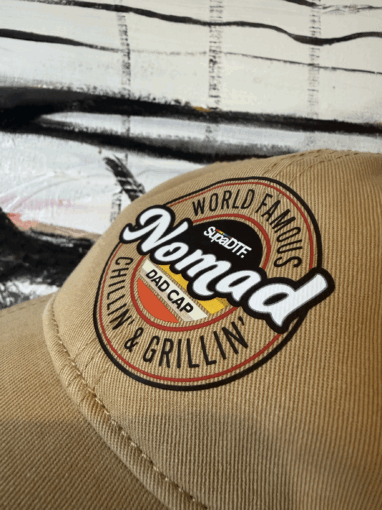 Nomad dad cap with brown embroidered logo close-up